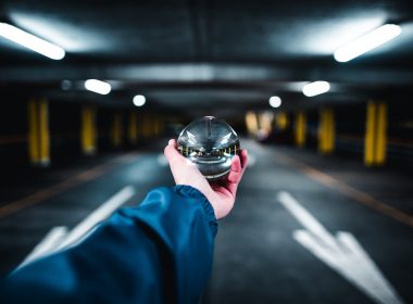 person holding grey glass ball