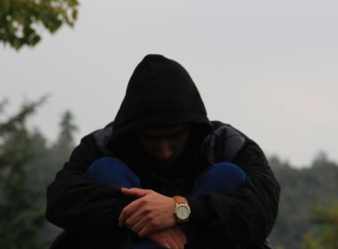 person in black hoodie and blue jacket