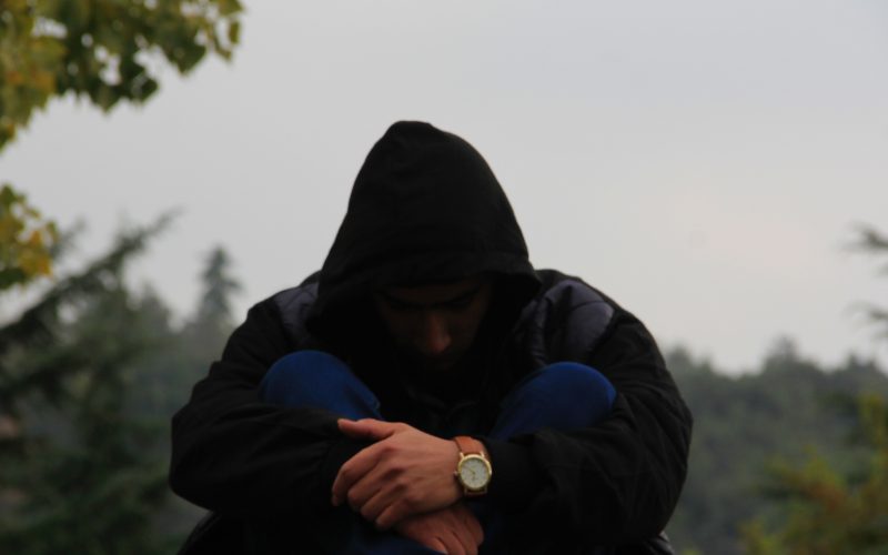 person in black hoodie and blue jacket