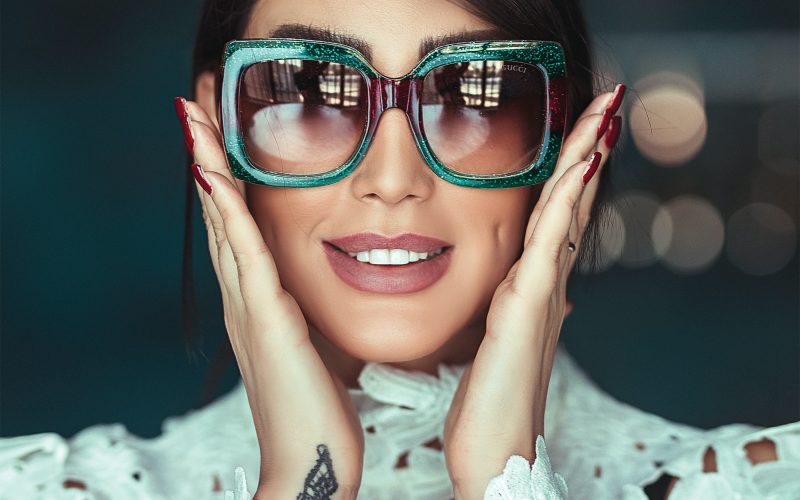 woman wearing green framed sunglasses