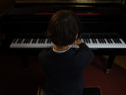 boy playing a piano