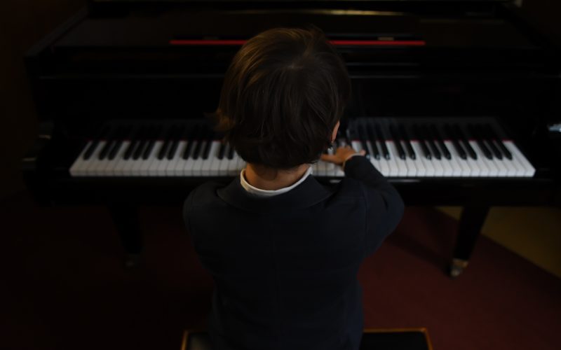 boy playing a piano