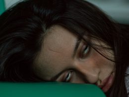 woman lying on green textile