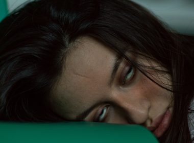 woman lying on green textile