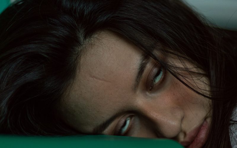 woman lying on green textile