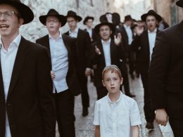 group of men walking on concrete road