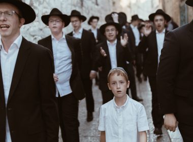 group of men walking on concrete road