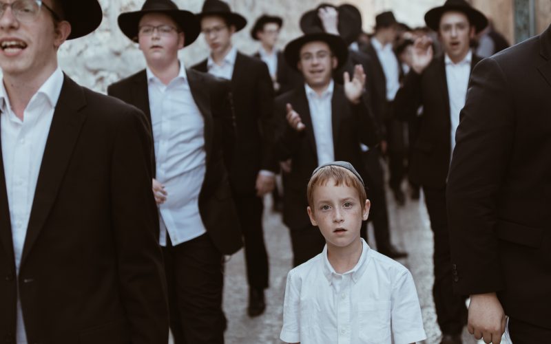 group of men walking on concrete road