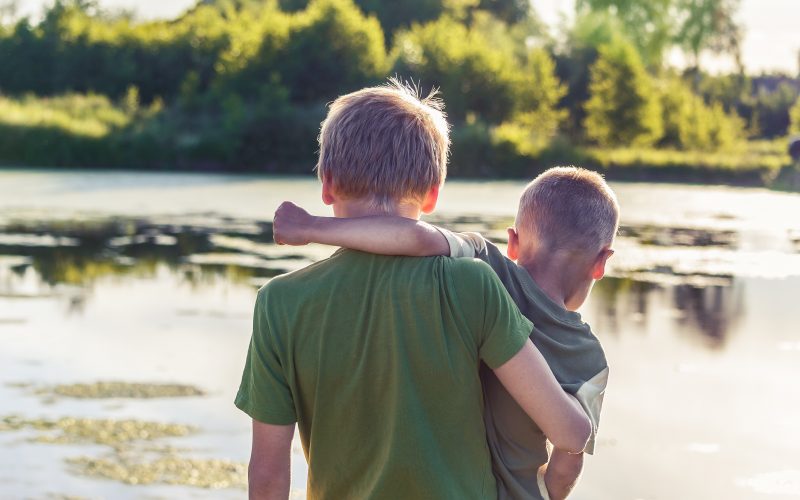 boy in green t-shirt standing beside boy in green t-shirt