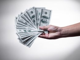 person holding 100 US Dollar banknote