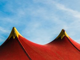 red and yellow umbrella under blue sky