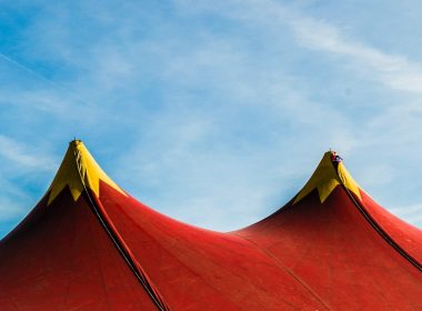 red and yellow umbrella under blue sky