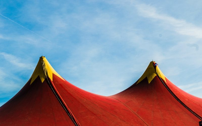 red and yellow umbrella under blue sky