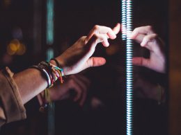 person wearing silver bracelet holding a light