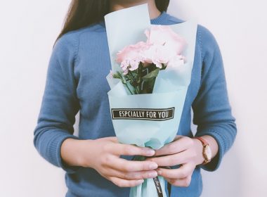 woman holding pink flower bouquet