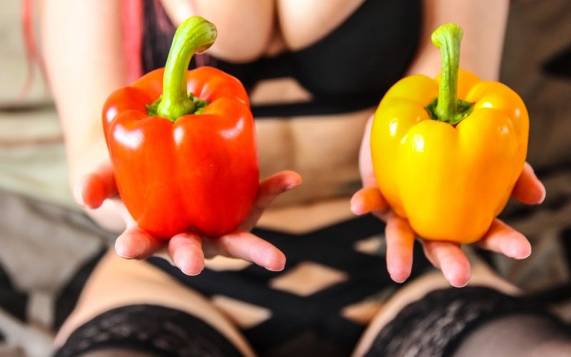 person holding yellow bell pepper