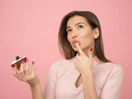 woman holding cake looking up