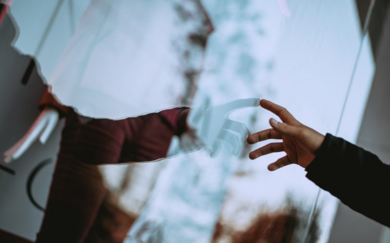 person holding glass wall