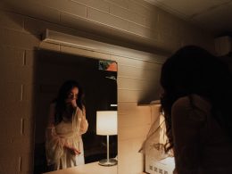 woman crying in front of mirror