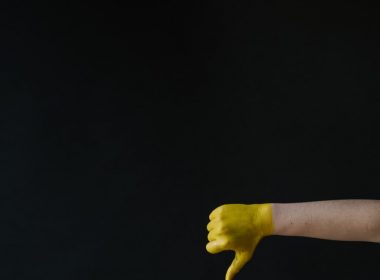 persons left hand with yellow paint