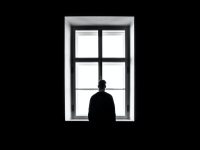 man standing in front of the window