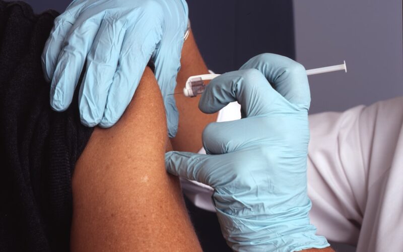 person in white gloves with blue textile on lap