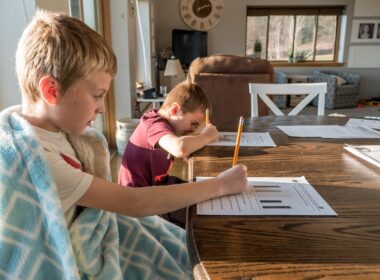 boy in gray crew neck t-shirt reading book